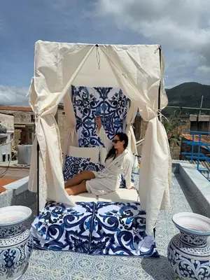 a man sitting in a gazebo on a patio at Opera Dolce in Carini