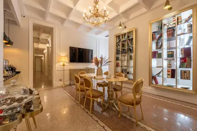 a dining room with a table and chairs and a chandelier at Villa Libertà in Palermo