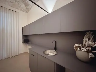 a kitchen with a sink and a vase on a counter at Corona Suite & Rooms in Palermo