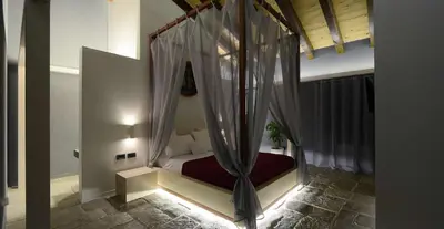 a small bedroom with a bed with curtains in a room at Agrirelais Principe SPA in San Giuseppe Jato