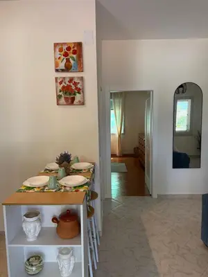 a dining room with a table and a mirror at Magaggiari Beach House in Cinisi