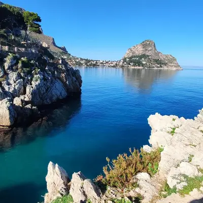a view of a large body of water with rocks at A' Terrazza in Santa Flavia