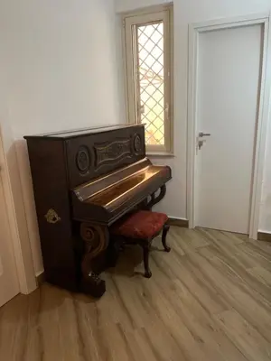 a piano sitting in a room next to a door at Sweetpalermo in Palermo