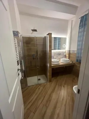 a bathroom with two sinks and a shower at Sweetpalermo in Palermo