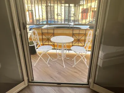a table and chairs in front of a window at Sweetpalermo in Palermo