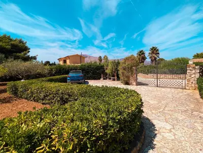 a blue car parked in front of a fence at Villa Betta Cuntrariusa con piscina privata e jacuzzi a Scopello in Castellammare del Golfo