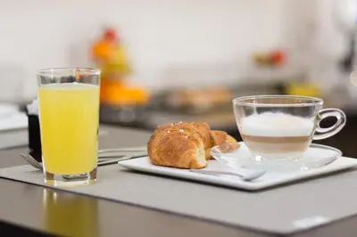 a plate of bread and a glass of orange juice at B&B Alla Stazione in Palermo