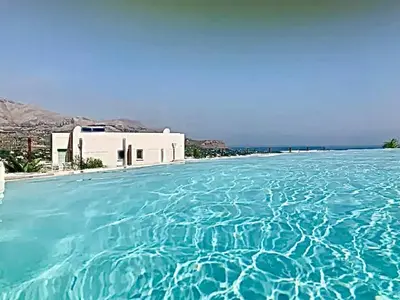 a large pool of blue water in front of a building at Giardino degli Allori, Villa Manfredi with Pool in Castellammare del Golfo