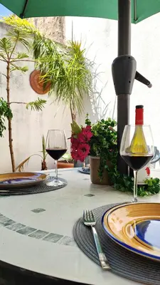 a table with two glasses of wine on it at Casa Bougainville, Mare e Relax in San Vito lo Capo