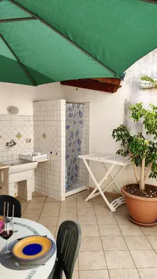 a dining room with a table and a green ceiling at Casa Bougainville, Mare e Relax in San Vito lo Capo