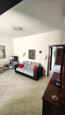 a living room with a couch and a table at Casa Bougainville, Mare e Relax in San Vito lo Capo