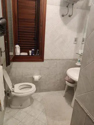 a bathroom with a toilet and a sink at Casa Bougainville, Mare e Relax in San Vito lo Capo