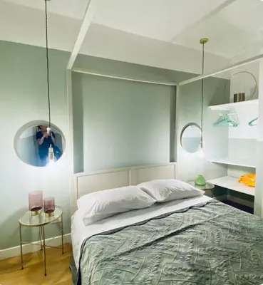 a bedroom with a bed and two round mirrors at Tarzana’ home in Palermo