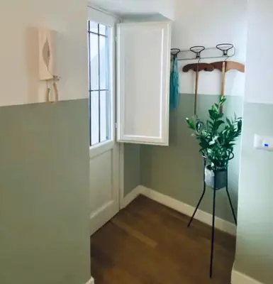 a hallway with a window and a potted plant at Tarzana’ home in Palermo