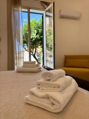 a room with towels on a table with a window at Expo1891 in Palermo