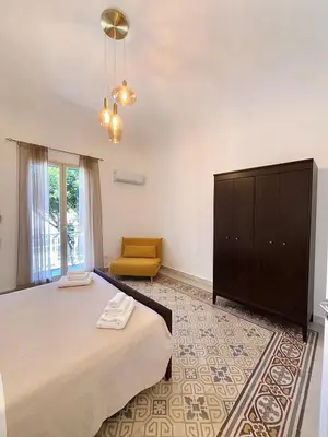 a bedroom with a large bed and a dresser at Expo1891 in Palermo
