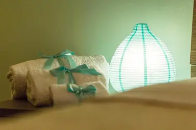 a lamp and two boxes with bows on a bed at Casetta Tiffany Mondello in Mondello