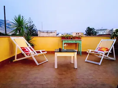 two chairs and a table on a patio at Casetta Tiffany Mondello in Mondello