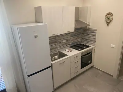 a kitchen with a white refrigerator and a stove at 4 Seasons in Altavilla Milicia