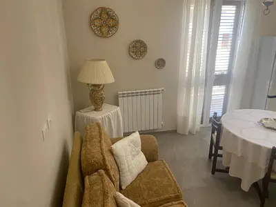 a living room with a chair and a table at 4 Seasons in Altavilla Milicia