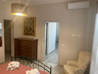 a living room with a bed and a chair at 4 Seasons in Altavilla Milicia
