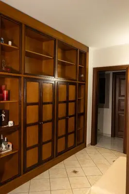 a room with wooden book shelves in a room at Appartamento centrale 2 camere a Termini Imerese - Marconi House in Termini Imerese