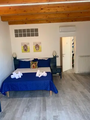 a bedroom with a blue bed with two towels on it at U muragghiuni n3 in Lascari