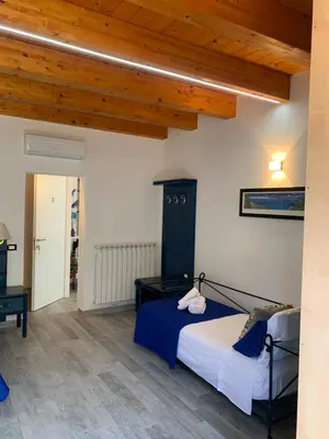 a bedroom with a bed and a wooden ceiling at U muragghiuni n3 in Lascari