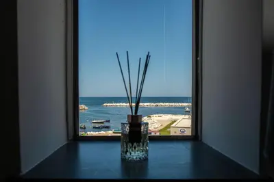 a window with a vase with sticks in it at Santerasmo rooms Charm in Palermo