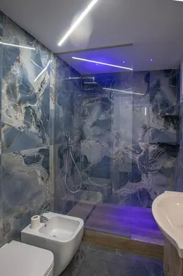 a bathroom with a shower and a toilet and a sink at Santerasmo rooms Charm in Palermo
