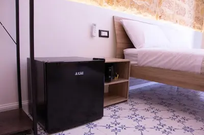 a room with a bed and a black amplifier at San Carlo Cuore di Palermo in Palermo