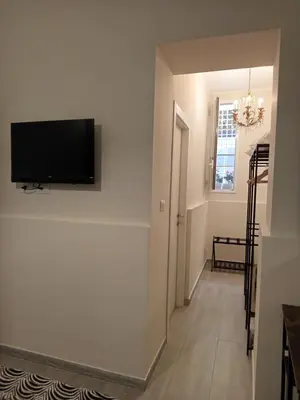 a hallway with a flat screen tv on a wall at Chez D'Ossuna con Patio Privato - centro storico Cattedrale - ampio 6 ospiti in Palermo