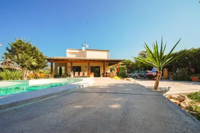 a villa with a swimming pool and a house at Villa Deluxe in Campofelice di Roccella