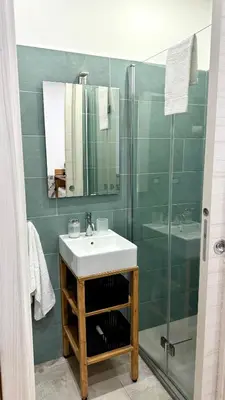 a bathroom with a sink and a shower at DiGi Home in Palermo