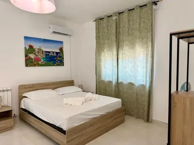 a bedroom with a bed with two towels on it at Villa GioEle - Pool & Relax in Mandra Capreria