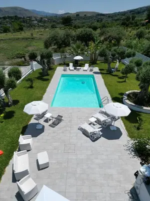 an overhead view of a swimming pool with chairs and umbrellas at Villa GioEle - Pool & Relax in Mandra Capreria