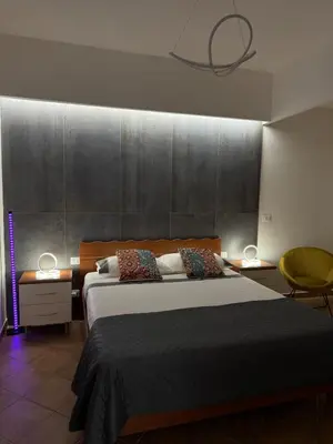 a bedroom with a large bed with two lamps on it at Domus Vucciria in Palermo