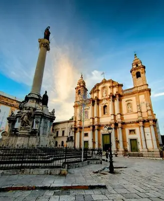 a large building with a monument in front of it at Domus Vucciria in Palermo