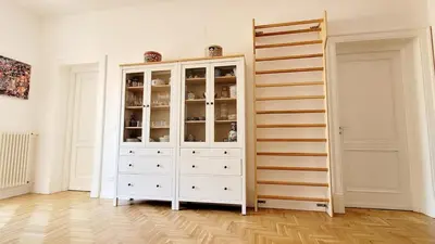 a white cabinet with glass doors in a room at Maison S Elena in Palermo