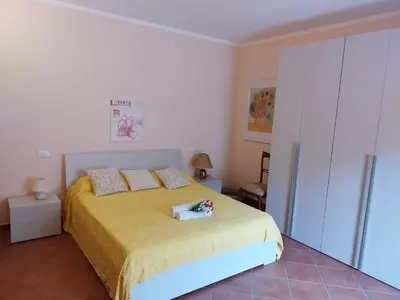 a bedroom with a large bed with two pillows at Villa Angel in Mandra Capreria