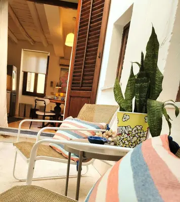 a patio with a table and a plant and a table at B-Twenty7 in Palermo
