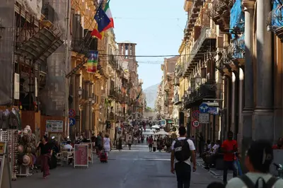 a busy city street with people walking down the street at I Paladini ORLANDO Apartment in Palermo