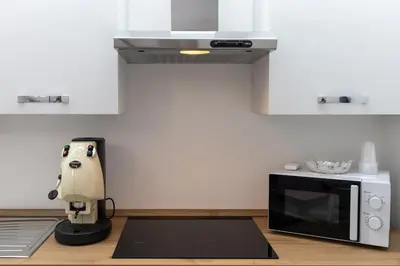 a coffee maker sitting on a counter next to a microwave at Luxury Royal House in Palermo