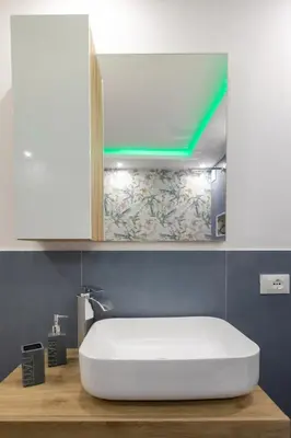 a bathroom with a white sink and a mirror at Luxury Royal House in Palermo