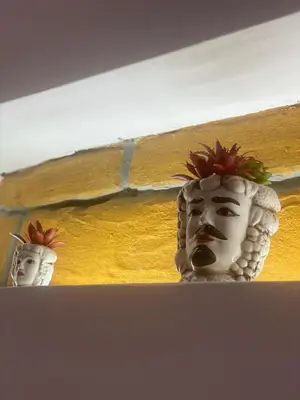 two white masks sitting on top of a shelf at Luxury Royal House in Palermo
