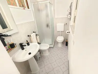 a bathroom with a sink and a toilet and a shower at subway apartment in Palermo