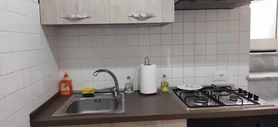 a kitchen counter with a sink and a stove at LA CASA DI ALISIA Palermo Centro in Palermo
