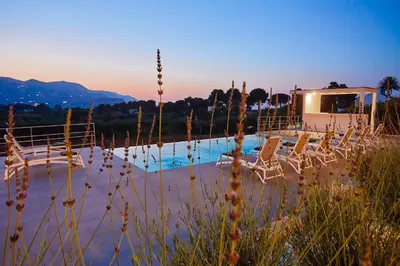 a group of chairs sitting next to a pool at Villa Allegra in Castellammare del Golfo
