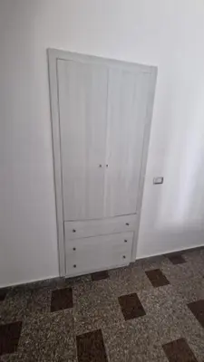 a white cabinet in the corner of a room at Arena Dorada apartaments Morrocoy in Balestrate