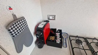 a corner of a kitchen with a stove with a pretend at Arena Dorada apartaments Morrocoy in Balestrate